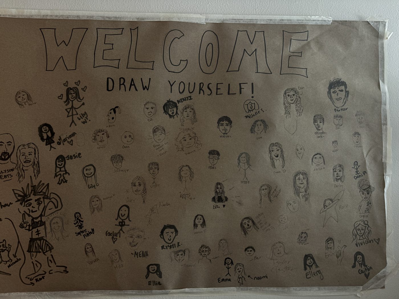 A hand-drawn welcome poster from Grace's freshman dorm covered in self-portraits and names