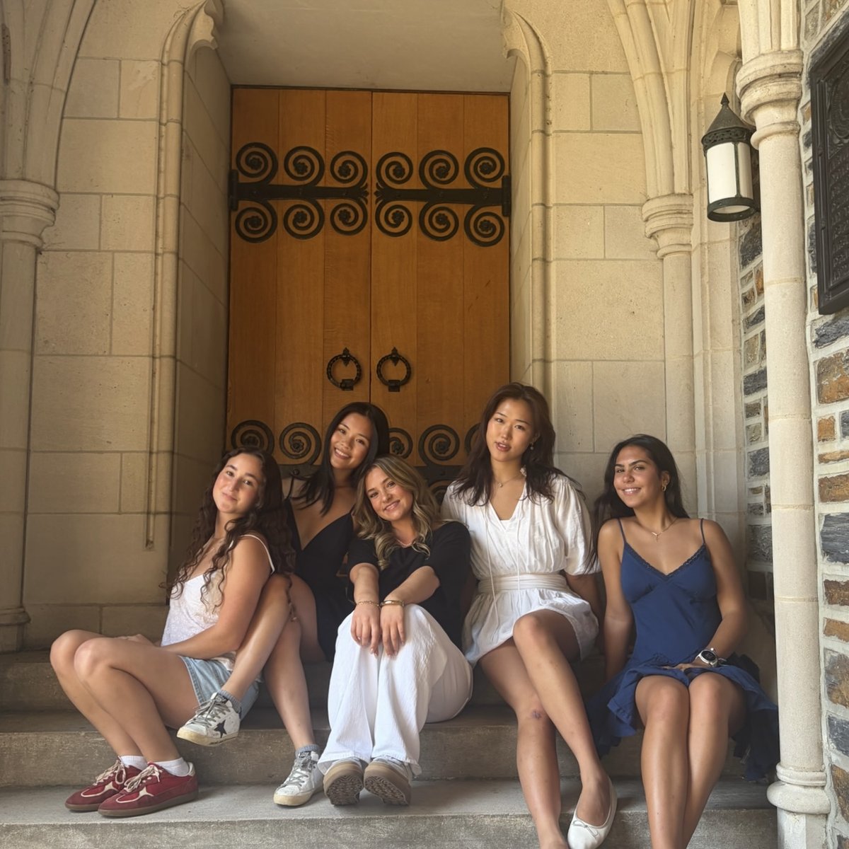 Grace and four friends sitting together on the Duke Chapel steps