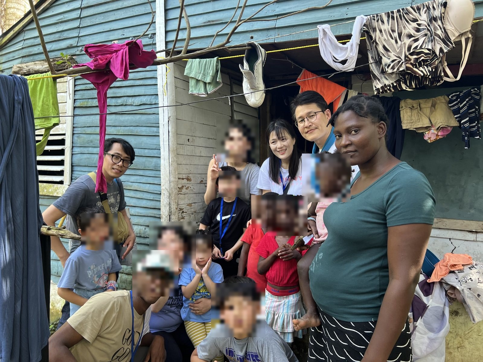 The team with a local family outside their home in the Dominican Republic