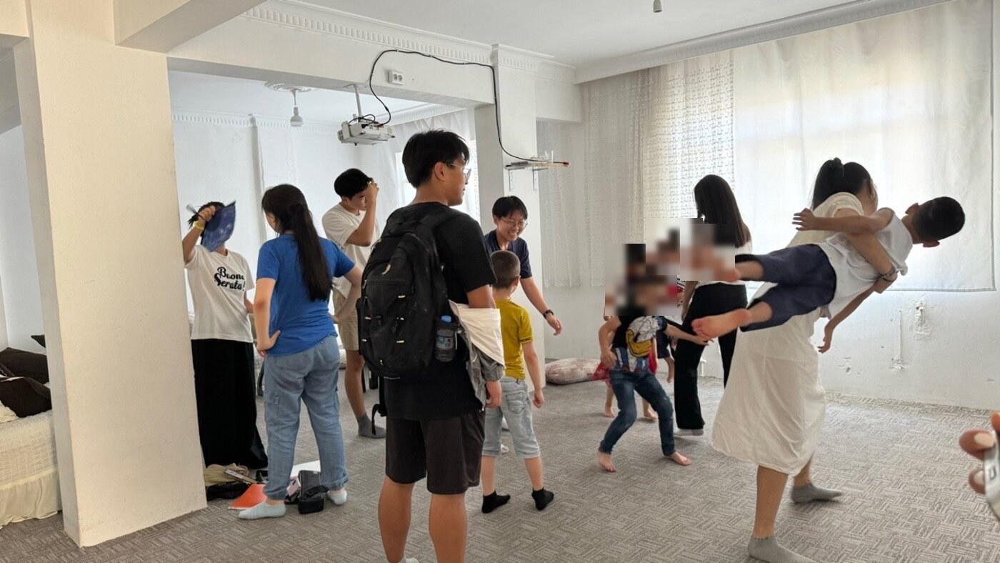 Playing games with children indoors during the Turkey service trip