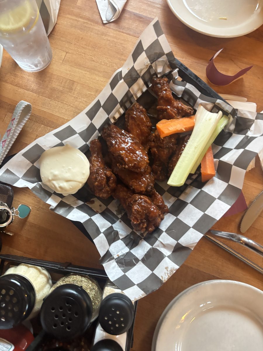 Korean fried chicken on checkered paper with pickled radish