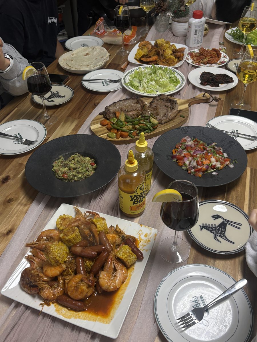 A crowded table of shared Mediterranean dishes