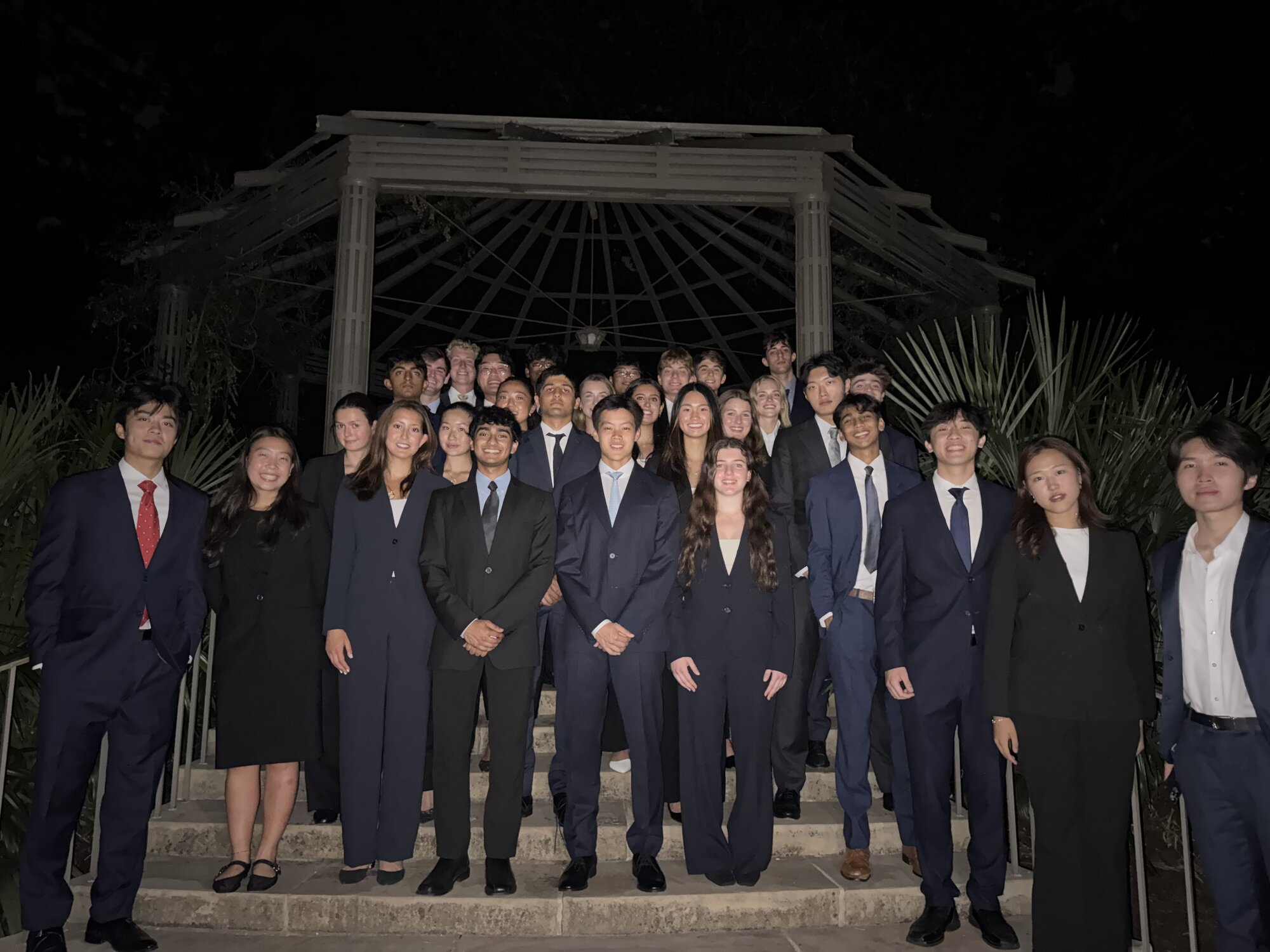 The Scale & Coin fall 2026 new member class on the same chapel steps at night