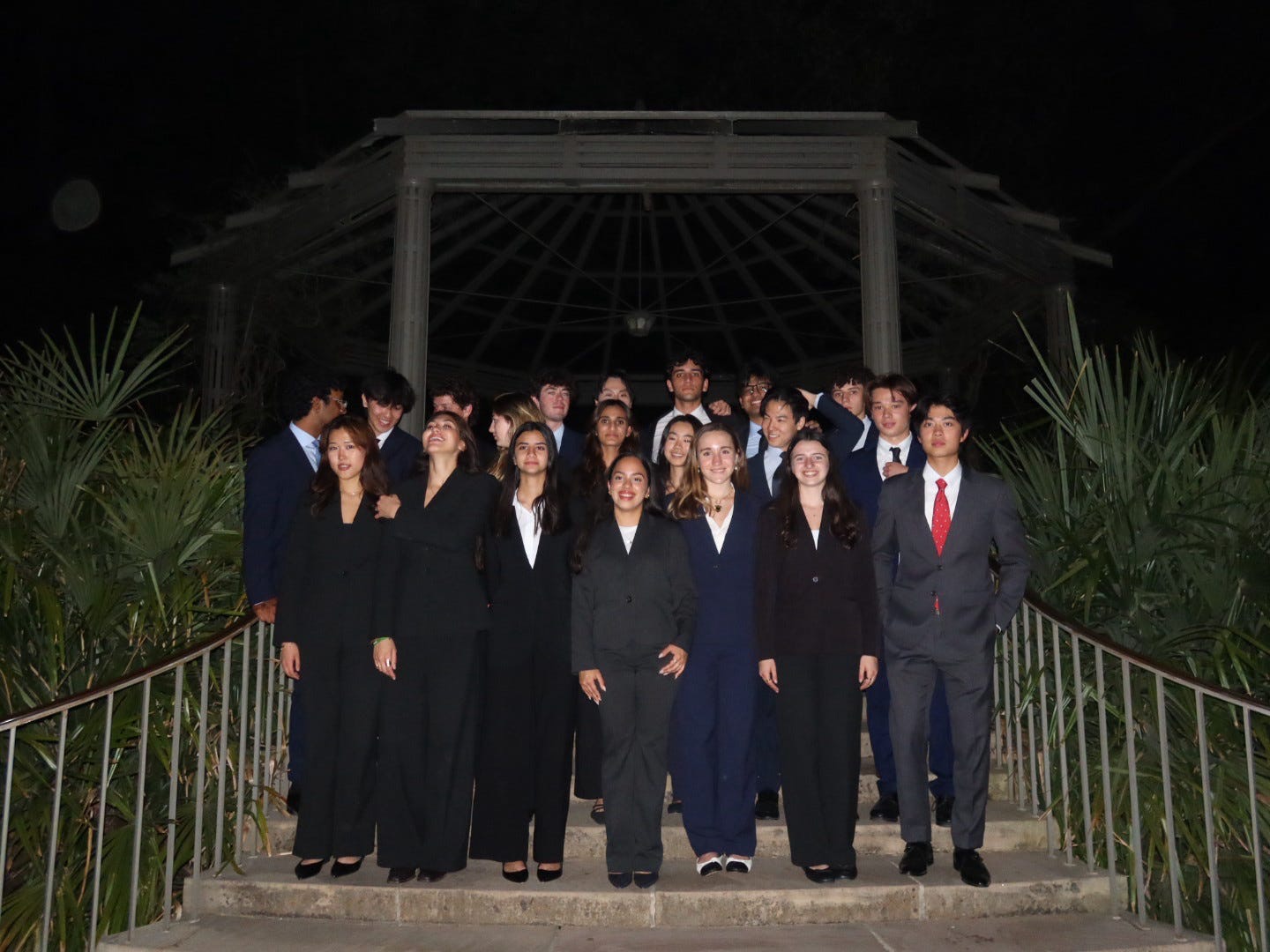 The Scale & Coin spring 2026 new member class on the chapel steps at night